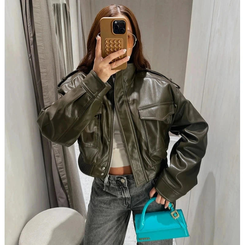 Chic cropped faux leather jacket with zipper closure and pockets, designed for casual wear and sporty style.