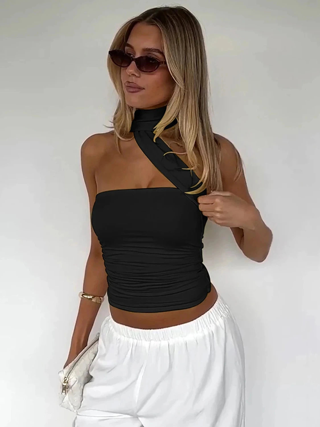 Halter ruched crop top with backless design and slight stretch for comfort. Ideal for casual outings and parties.