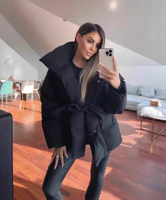 Belted puffer coat featuring a loose fit, made from cotton and polyester, designed for winter office wear.