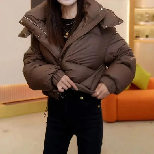 Cropped hooded puffer jacket made of cotton, designed for lightweight warmth and regular fit, suitable for casual wear.