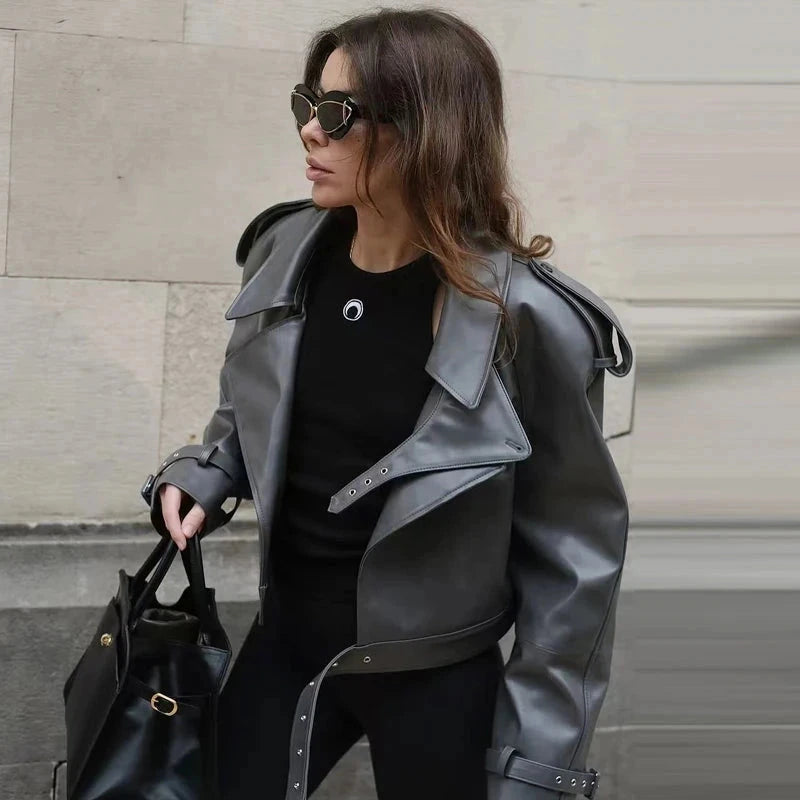 Cropped leather jacket with single button closure and loose fit, ideal for layering during autumn outings.
