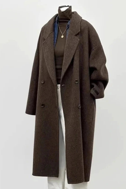 Double-sided woolen coat with double-breasted closure, turn-down collar, and pockets in a wide-waisted silhouette.