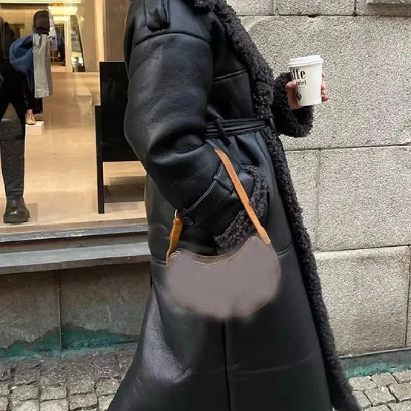 Luxe faux leather long jacket with fur trim, lapel collar, and belted waist for a standard fit.