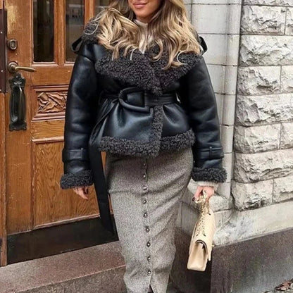 Luxe faux leather long jacket with fur trim, lapel collar, and belted waist, made from polyester. Standard fit.