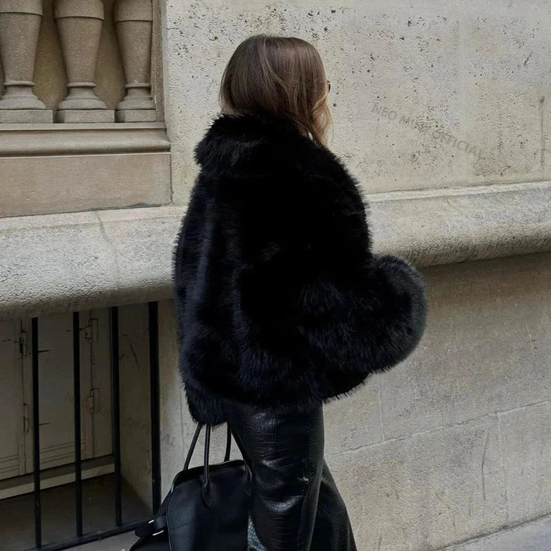 Chic faux leather fur shawl collar coat with a modern silhouette and wide-waisted, short length design.