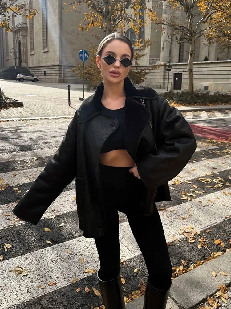 Chic vintage-inspired faux leather fur jacket with a loose fit, single-breasted design, and practical pockets.