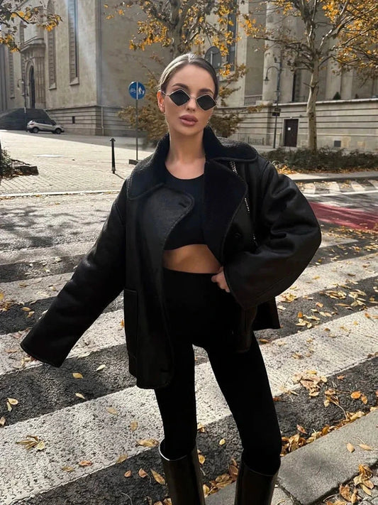 Chic vintage-inspired faux leather fur jacket with a loose fit, single-breasted design, and practical pockets.