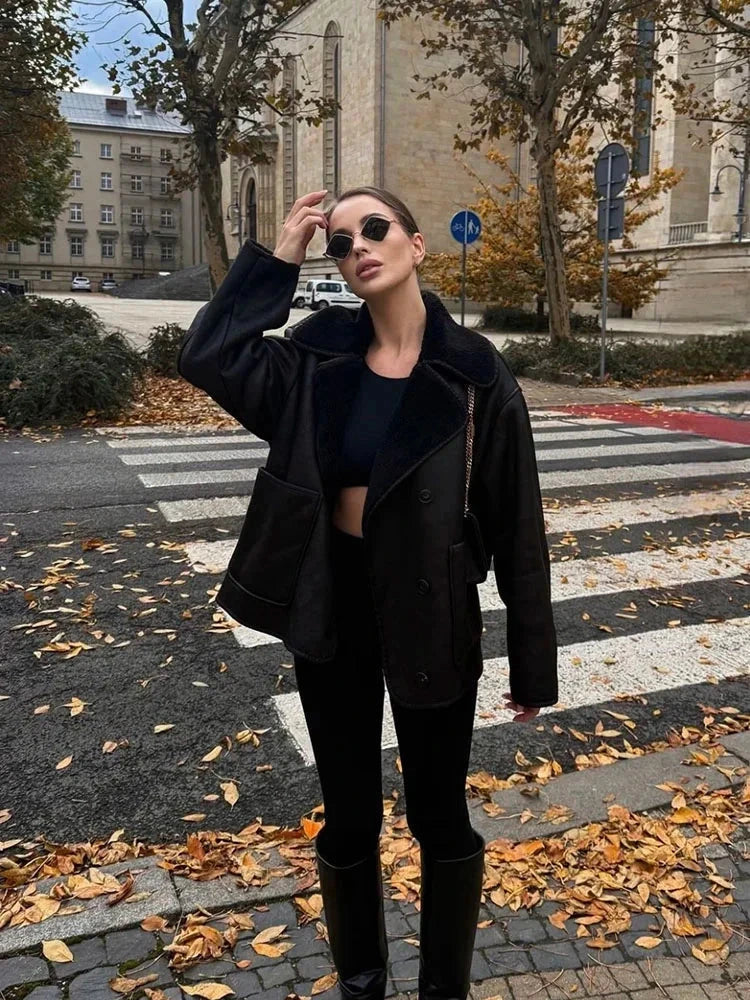 Chic vintage-inspired faux leather fur jacket with a loose fit, single-breasted design, and practical pockets.