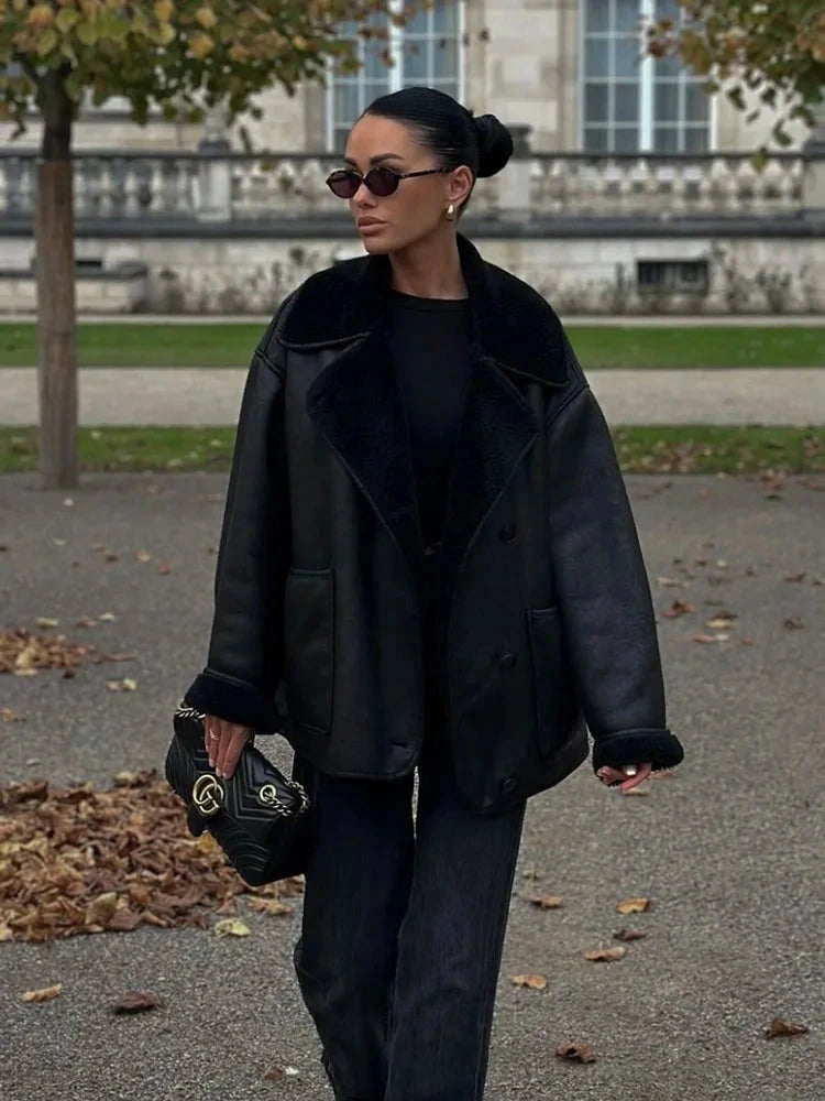 Chic vintage-inspired faux leather fur jacket with a loose fit, single-breasted design, and practical pockets.