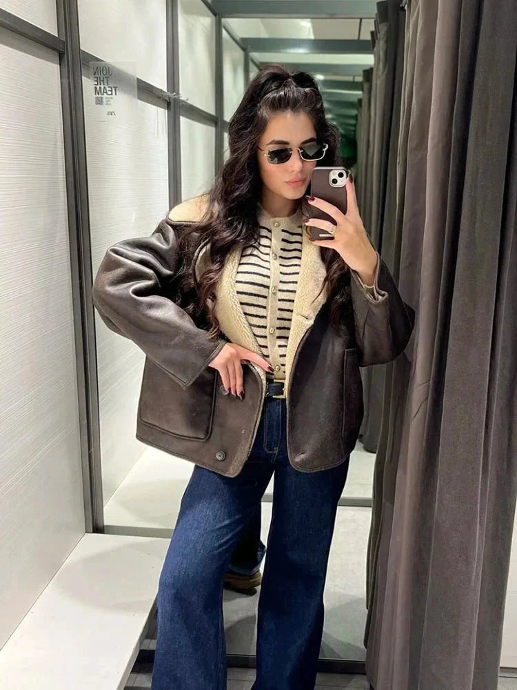 Chic vintage-inspired faux leather fur jacket with a loose fit, single-breasted design, and practical pockets.