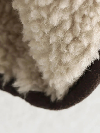 Chic vintage-inspired faux leather fur jacket with a loose fit, single-breasted design, and practical pockets.