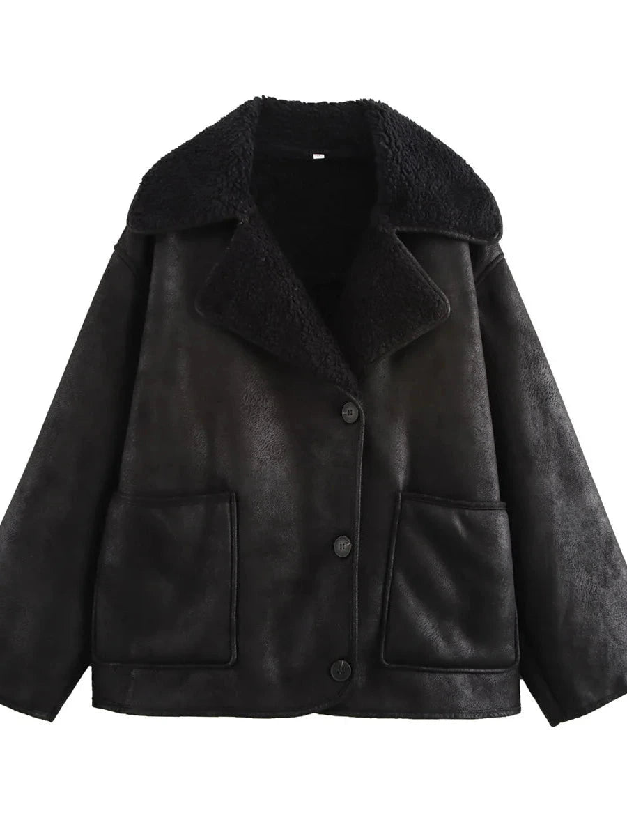 Chic vintage-inspired faux leather fur jacket in charcoal black with pockets and a loose fit.
