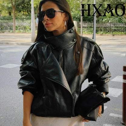 Cropped faux leather bomber jacket with snap button closure, ideal for layering in cooler weather.