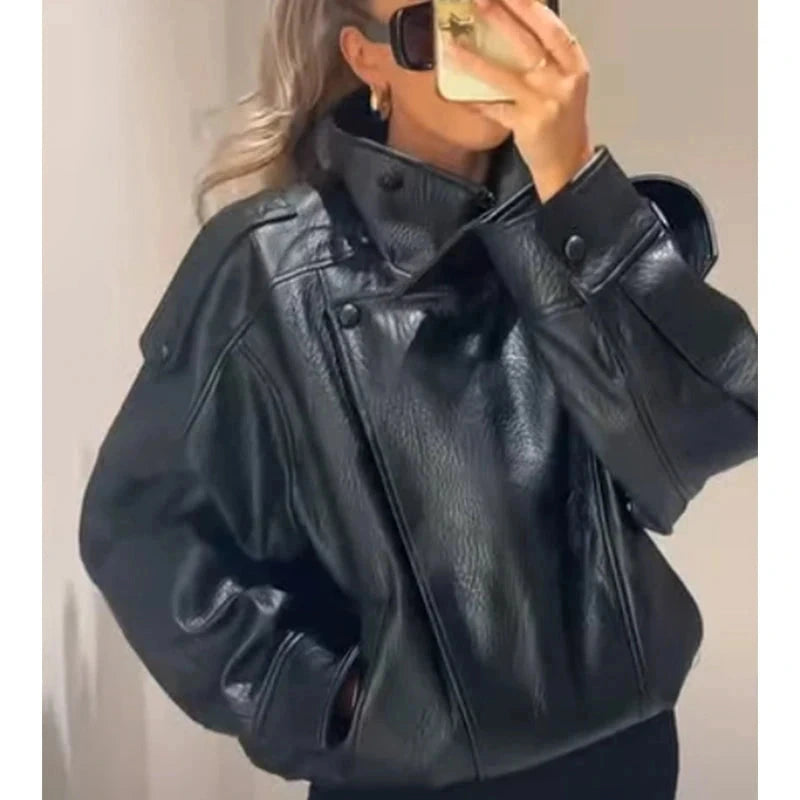 Cropped faux leather bomber jacket with snap button closure, ideal for layering in cooler weather.