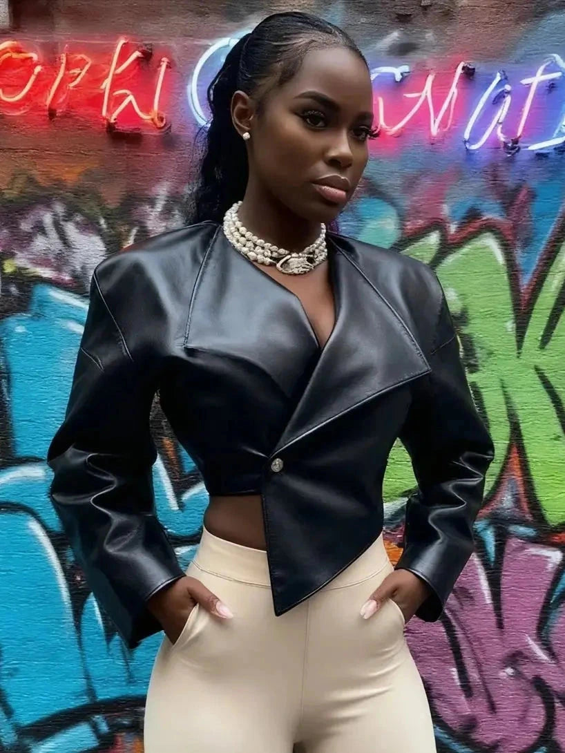 Chic faux leather crop jacket with a tailored silhouette and single button closure, suitable for casual or office wear.
