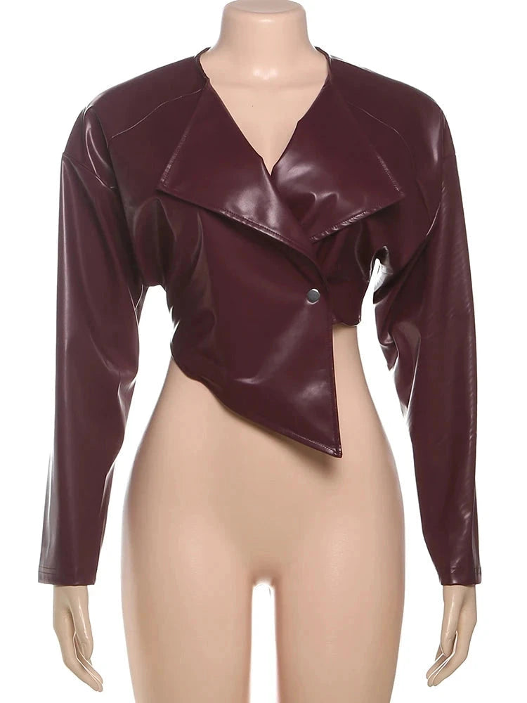 Chic faux leather crop jacket with a tailored silhouette and single button closure, suitable for office or casual wear.