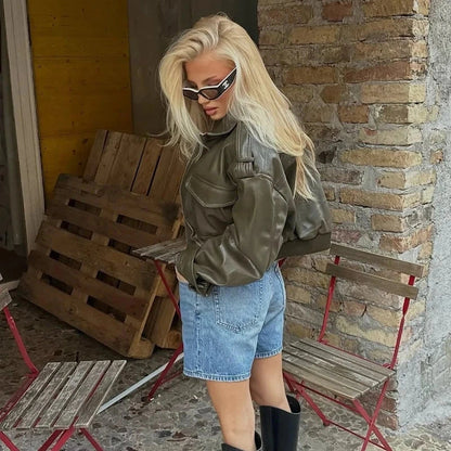 Chic cropped faux leather jacket with zipper closure and pockets, designed for casual wear and sporty style.