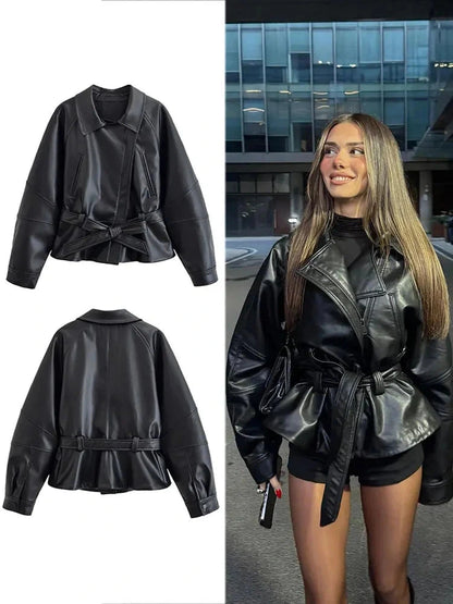 Chic faux leather trench coat with zipper closure and belted waist, designed for modern elegance and layering.