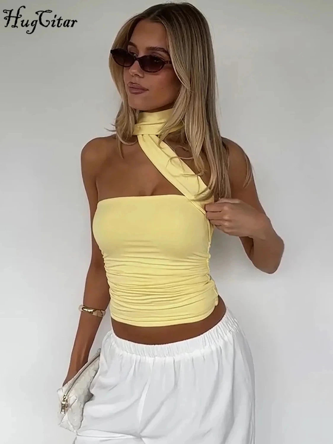Halter ruched crop top with backless design and slight stretch for comfort. Ideal for casual outings or parties.