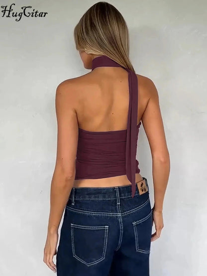 Halter ruched crop top with backless design and slight stretch for comfort. Ideal for casual outings or parties.