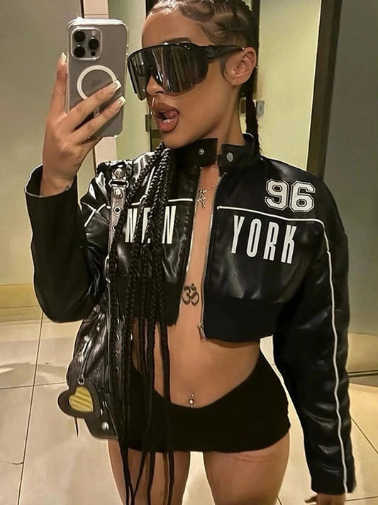 Black crop jacket with white letter print on the front, featuring a zip closure and long sleeves.
