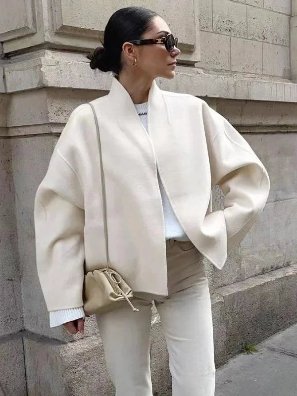 Contemporary loose fitting short jacket with open stitch closure, crafted from high-quality polyester.