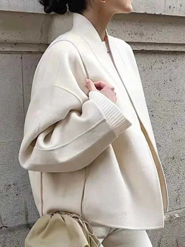 Contemporary loose fitting short jacket with open stitch closure, crafted from high-quality polyester.