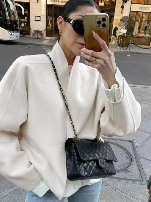 Contemporary loose fitting short jacket with open stitch closure, crafted from high-quality polyester.