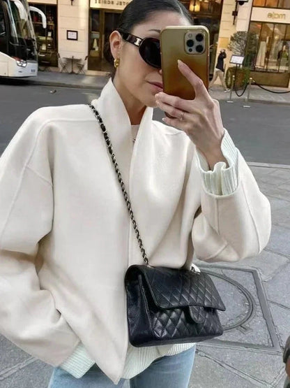 Contemporary loose fitting short jacket with open stitch closure, crafted from high-quality polyester.