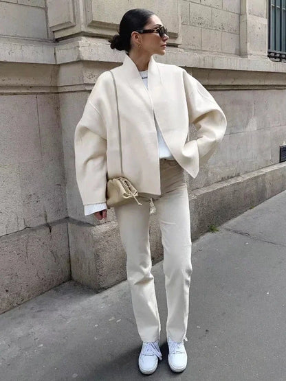 Contemporary loose fitting short jacket with open stitch closure, crafted from high-quality polyester.