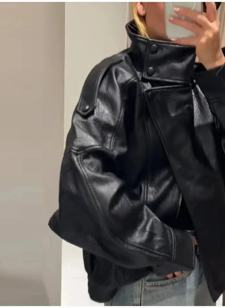 Black loose PU leather jacket with a zip front and side pockets, displayed on a white background.