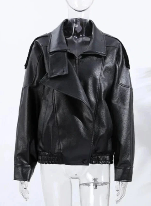 Black loose-fitting PU leather jacket with a front zipper and side pockets, displayed on a hanger against a neutral background.