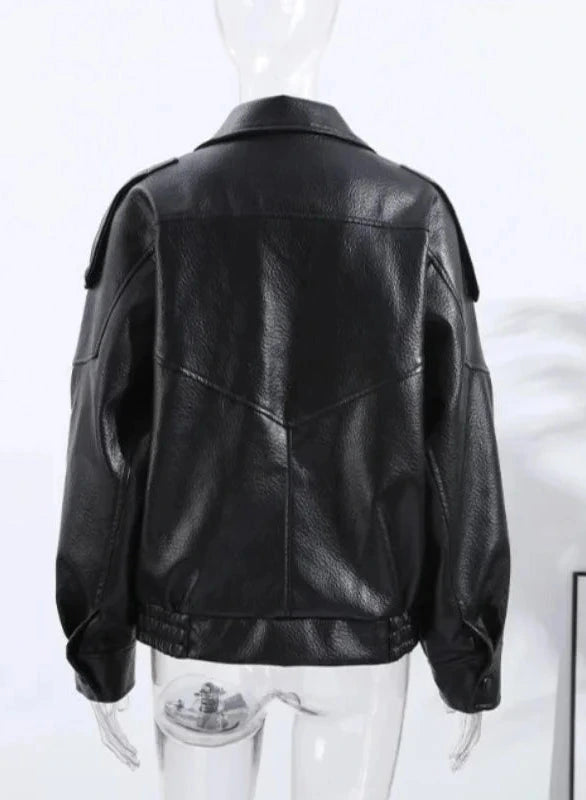 Black loose PU leather jacket with a relaxed fit and zippered front, displayed on a hanger against a neutral background.