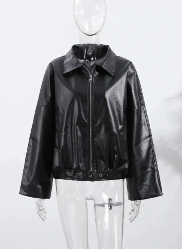 Black loose PU leather jacket with a relaxed fit and zippered front, displayed on a hanger against a neutral background.