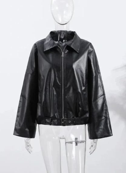 Black loose PU leather jacket with a relaxed fit and zippered front, displayed on a hanger against a neutral background.