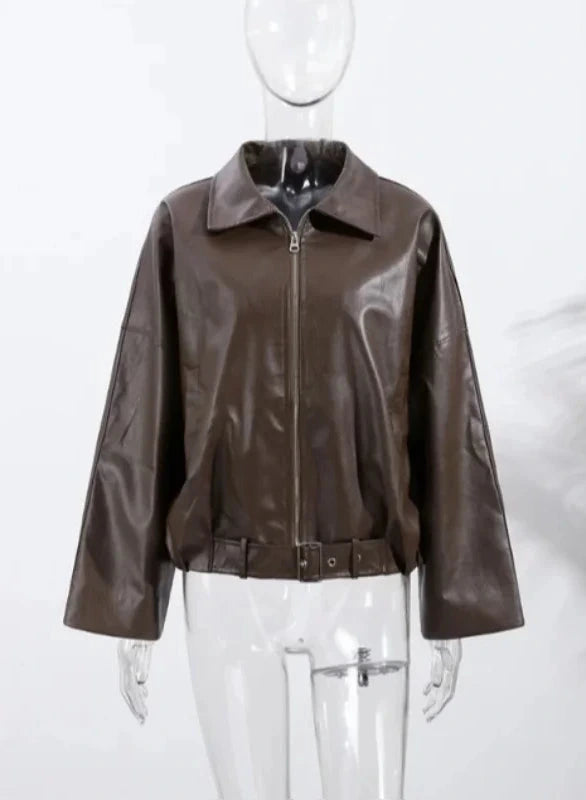 Loose black PU leather jacket with a front zipper and side pockets, displayed on a hanger against a neutral background.