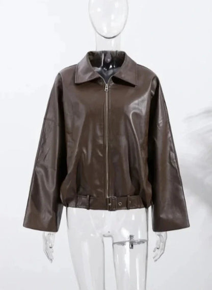 Loose black PU leather jacket with a front zipper and side pockets, displayed on a hanger against a neutral background.