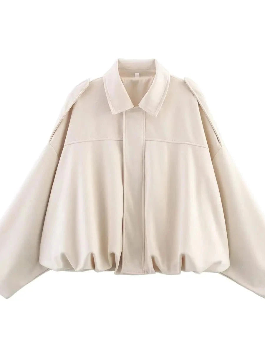 Cream beige oversized bomber jacket with zipper closure and pockets, made from polyester material.