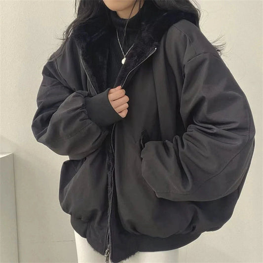 Oversized hooded parka in dark green with a front zipper and large pockets, displayed on a white background.