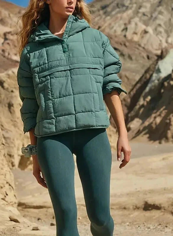 Muted green cozy oversized puffer jacket with a hood, designed for casual layering and comfort.