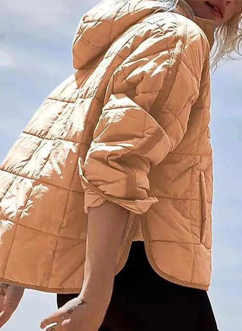 Light beige cozy oversized puffer jacket with a hood, designed for casual layering and comfort.