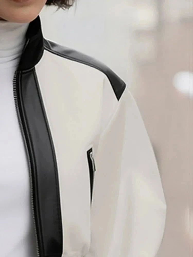 Cropped puff sleeve stand collar jacket in a PU leather blend with zipper closure and contrast color details.