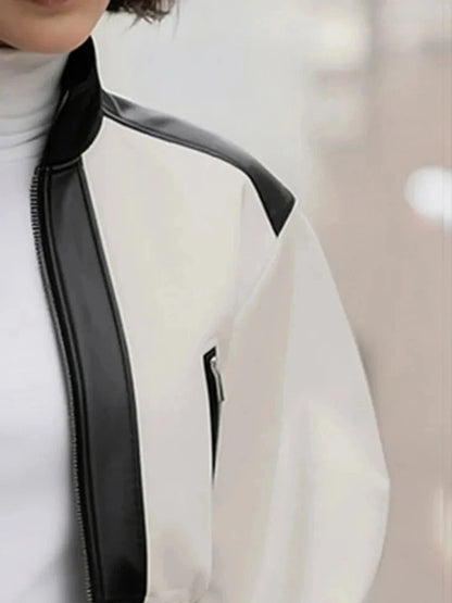 Cropped puff sleeve stand collar jacket in a PU leather blend with zipper closure and contrast color details.