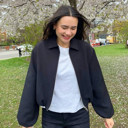 Cropped puffed bomber jacket with relaxed fit and zipper closure, made from quality polyester.