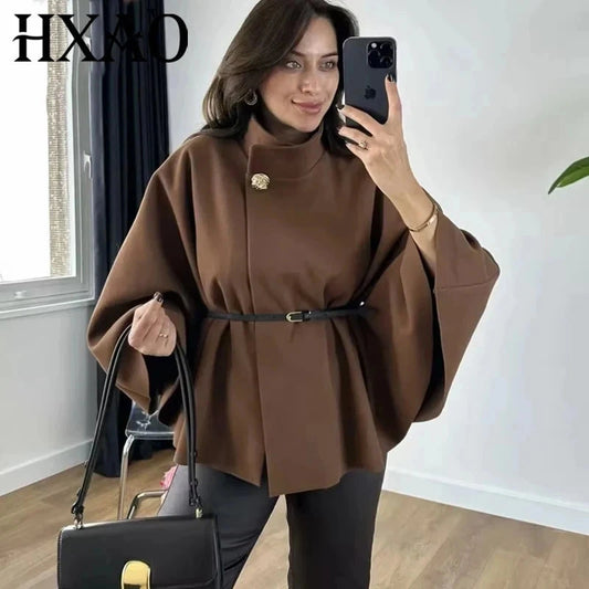 Elegant short cape coat with turtleneck collar and belt closure, made from polyester, ideal for layering.