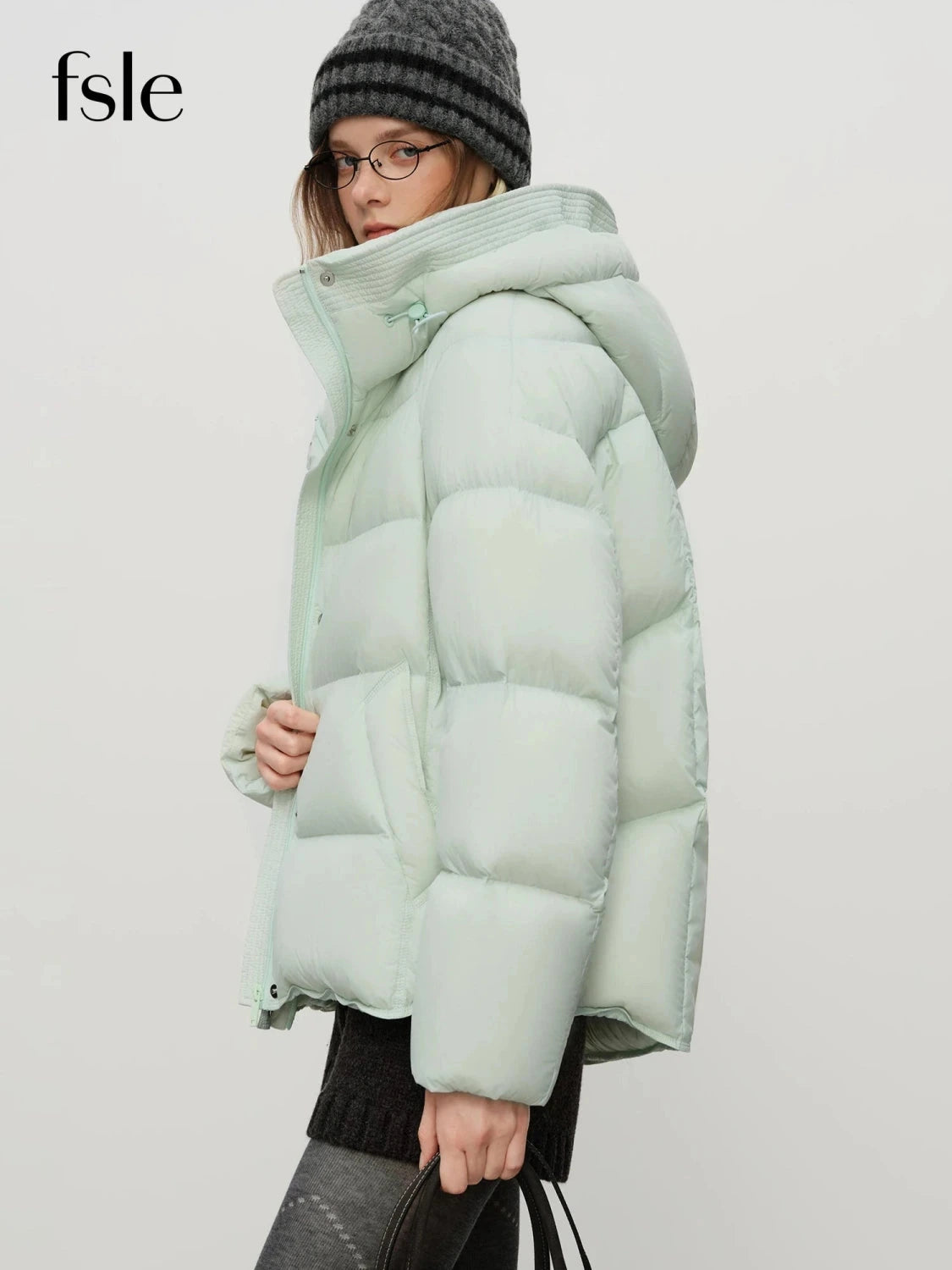 Contemporary short hooded puffer jacket with bat sleeves and duck down filling for warmth and comfort.