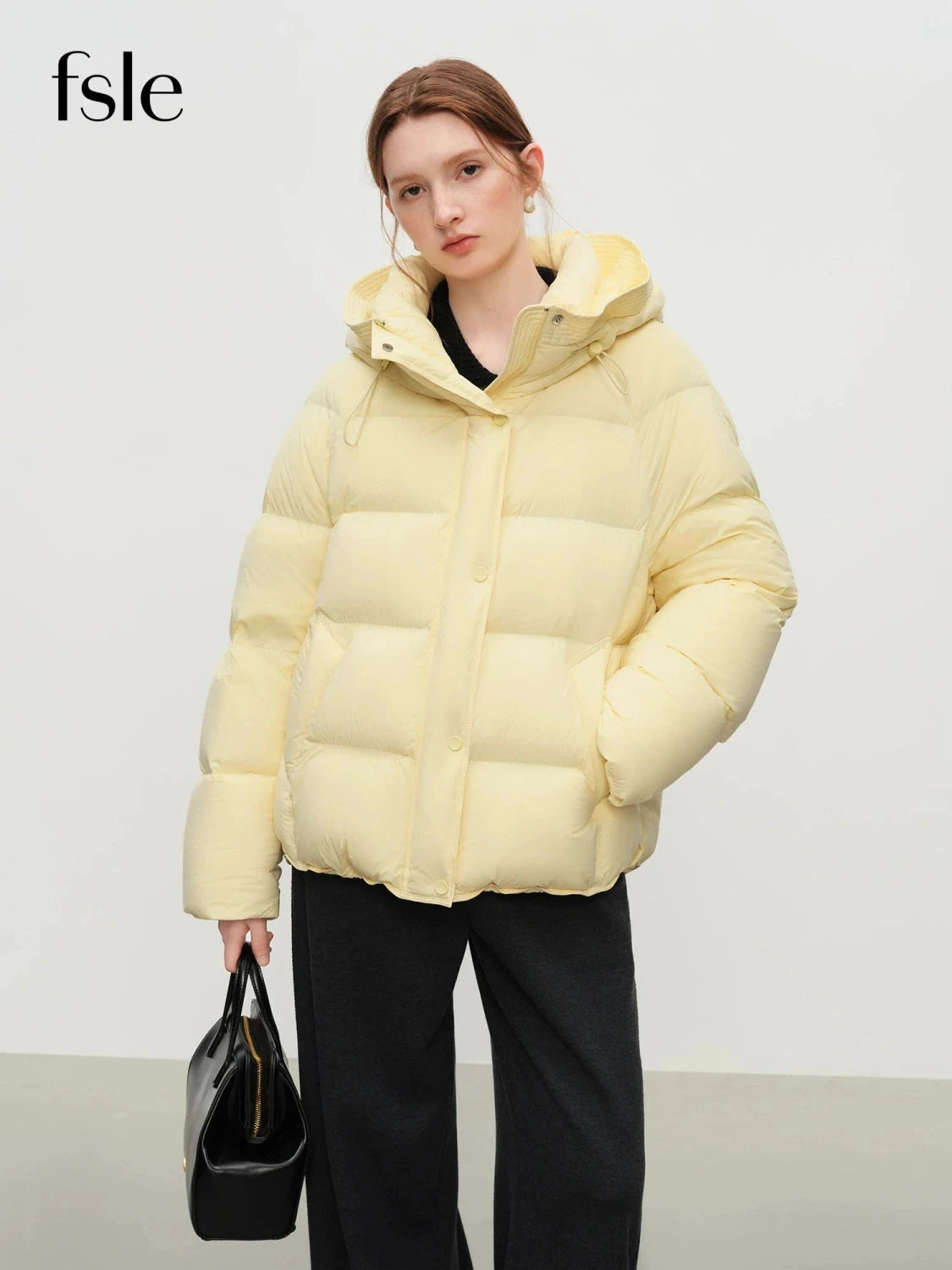 Contemporary short hooded puffer jacket with bat sleeves and duck down filling for warmth and comfort.