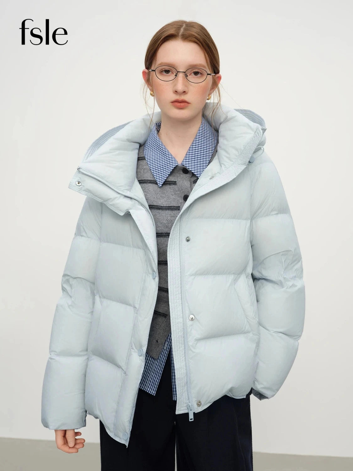 Contemporary short hooded puffer jacket with bat sleeves and duck down filling for warmth and comfort.