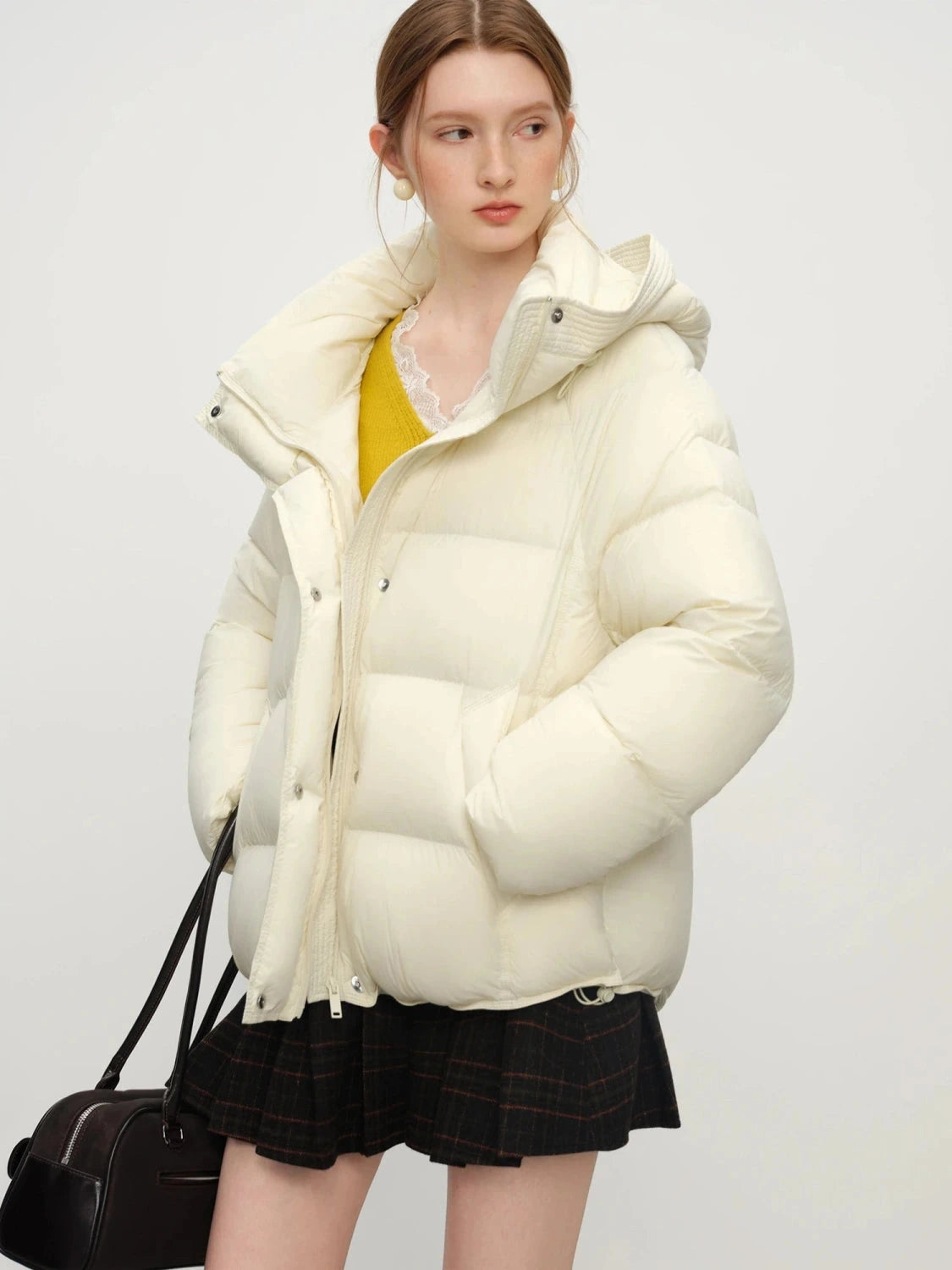 Cream white contemporary short hooded puffer jacket with bat sleeves and duck down filling for warmth.