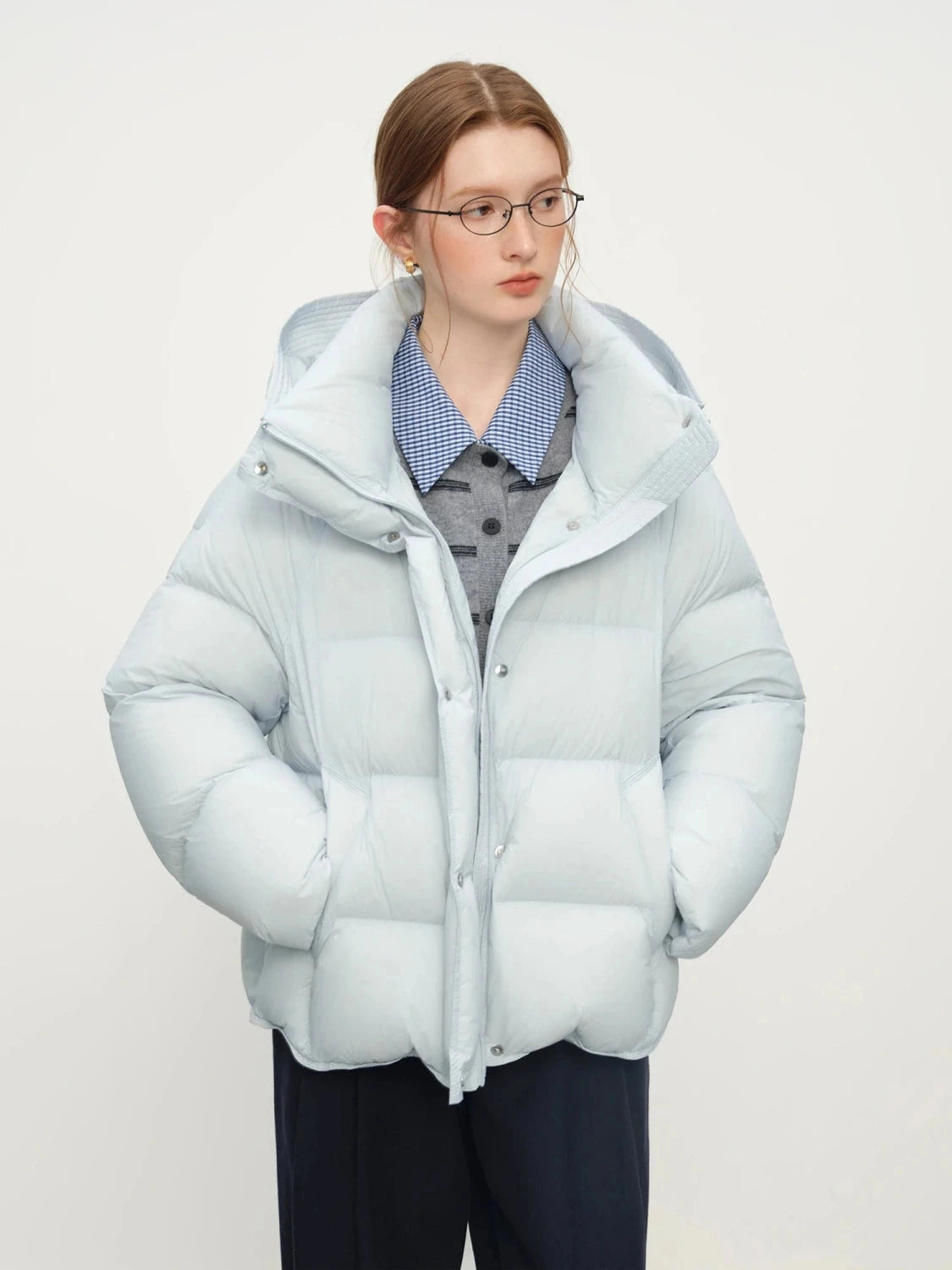 Sky blue contemporary short hooded puffer jacket with bat sleeves and duck down filling for warmth.